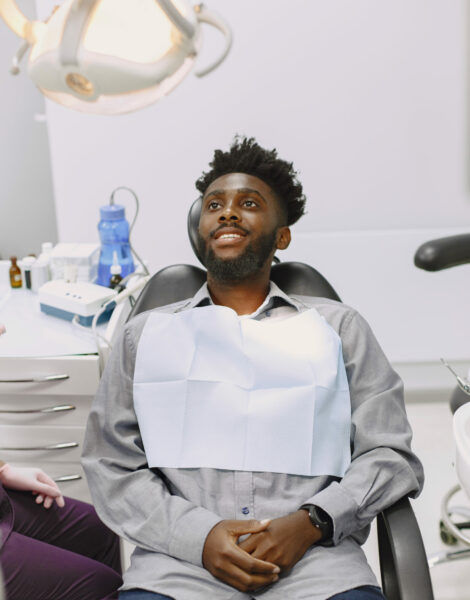 African patient in dentistry sitting in dental chair